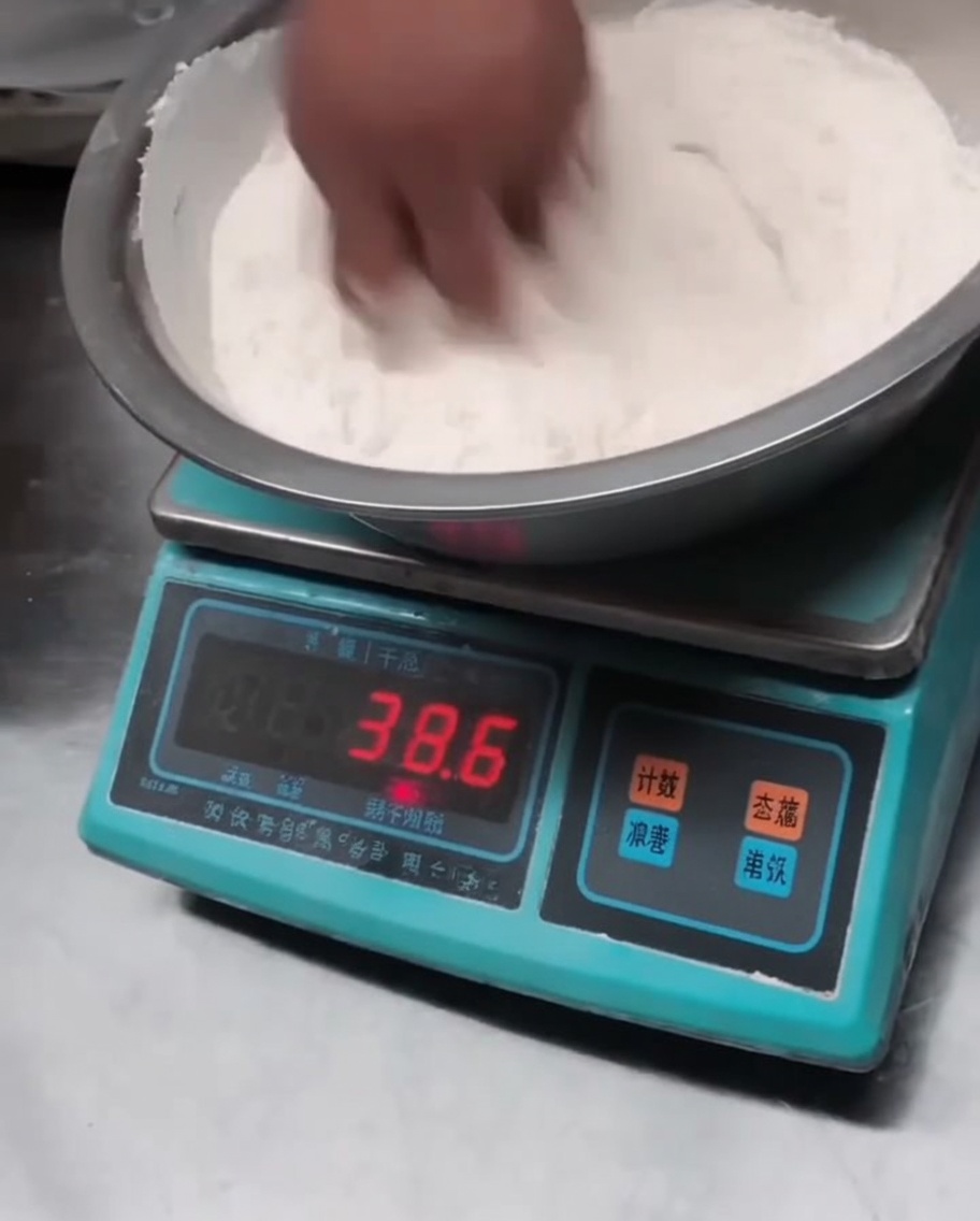 Trockenes Mehl wird in einer großen Schüssel mit Salz und Alkalipulver vermengt.
