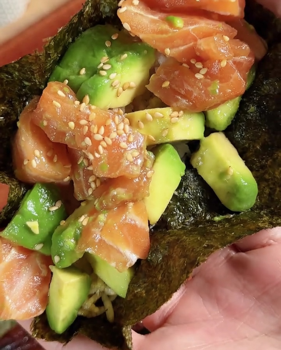 Ein kreisförmiges Stück Sushi-Nori wird aus einem größeren Blatt ausgeschnitten.