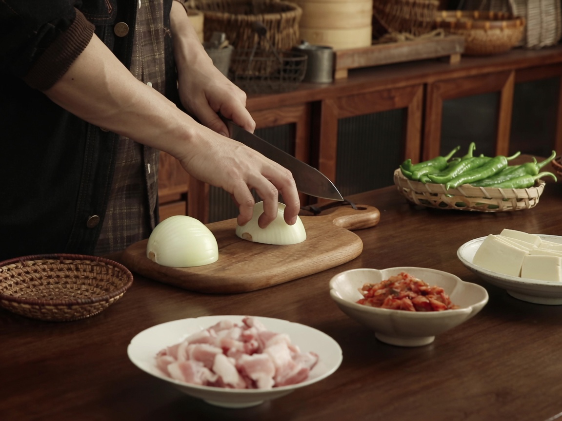 Finely sliced white onion pieces piled on the cutting board.