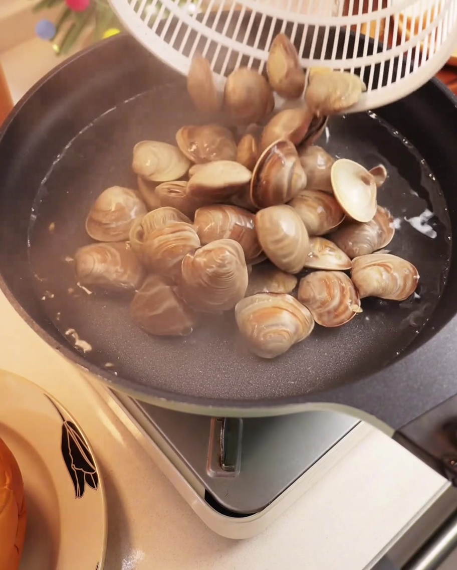 Frische Muscheln kochen in einem Topf mit Wasser, die Schalen öffnen sich.