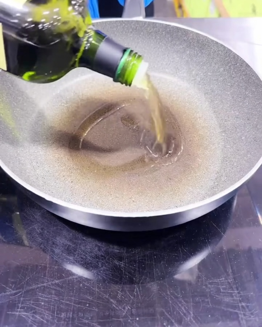Avocadoöl wird in eine vorgeheizte Pfanne gegossen.