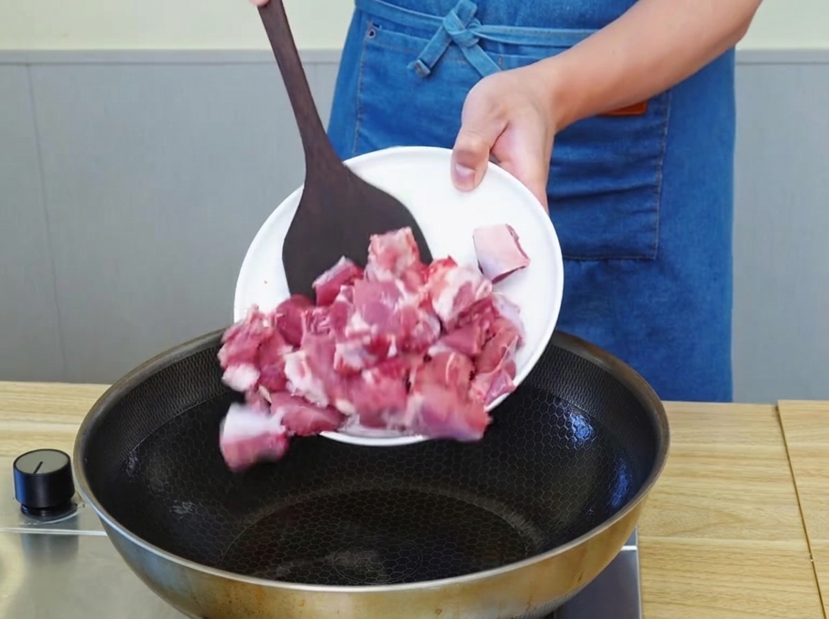 Rinderstücke braten in einer Pfanne mit heißem Öl und entwickeln eine goldbraune Kruste.