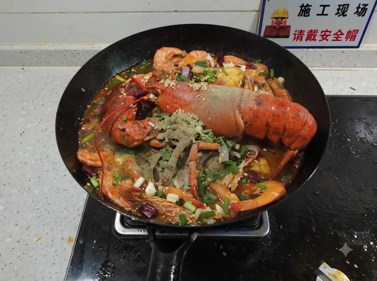 Rauchend heißes Öl wird über trockene Gewürze und Frühlingszwiebeln gegossen, die auf einer gekochten Meeresfrüchte-Platte im Wok liegen.
