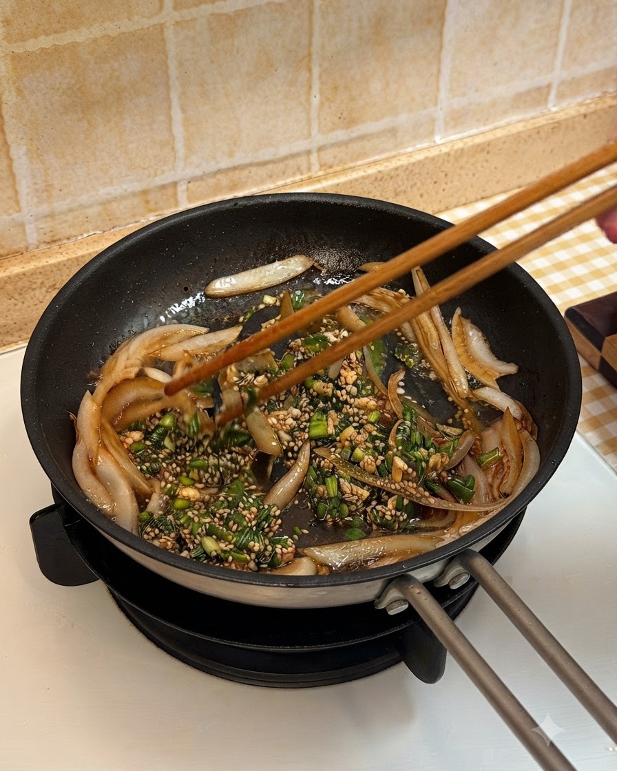 Gekochtes Rindfleisch wird in die Pfanne gegeben und mit Zwiebeln und Sauce vermischt.