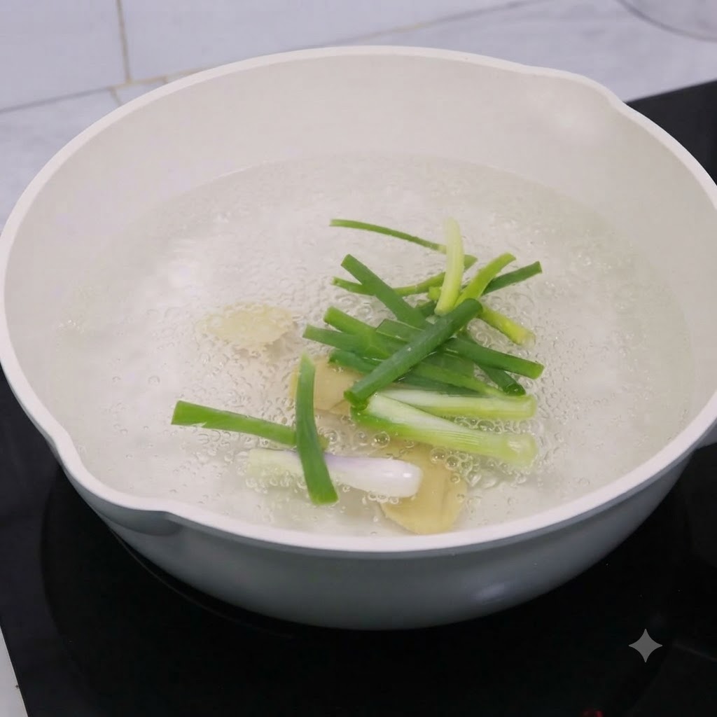 Ingwerscheiben und Frühlingszwiebeln kochen in einem Topf mit Wasser und Kochwein.